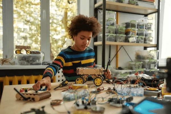boy building toy car