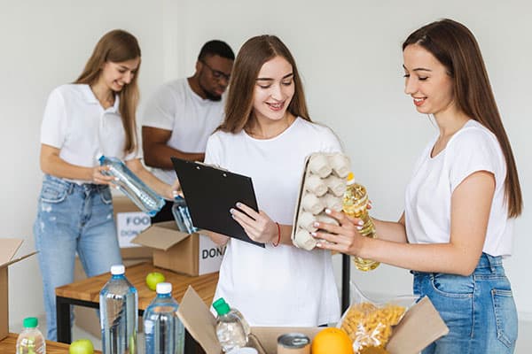 teen girls volunteering at food bank