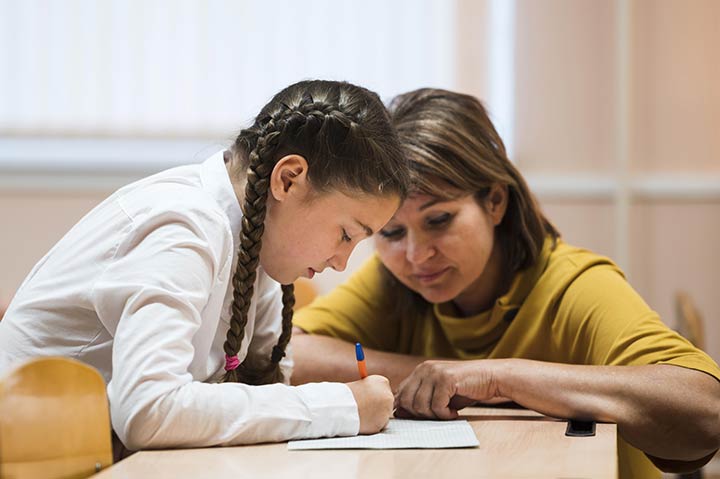 teacher working with middle school student