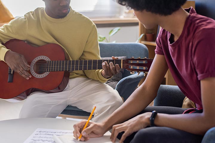 young school students playing guitar